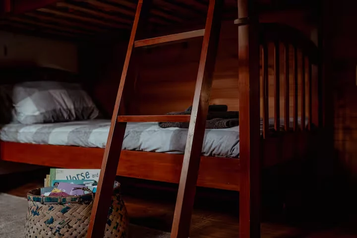 Cosy timber bunk room with ladder