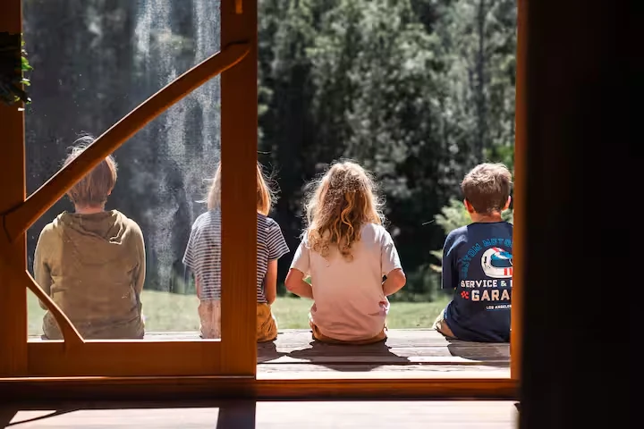 Children sitting together on the sunny veranda