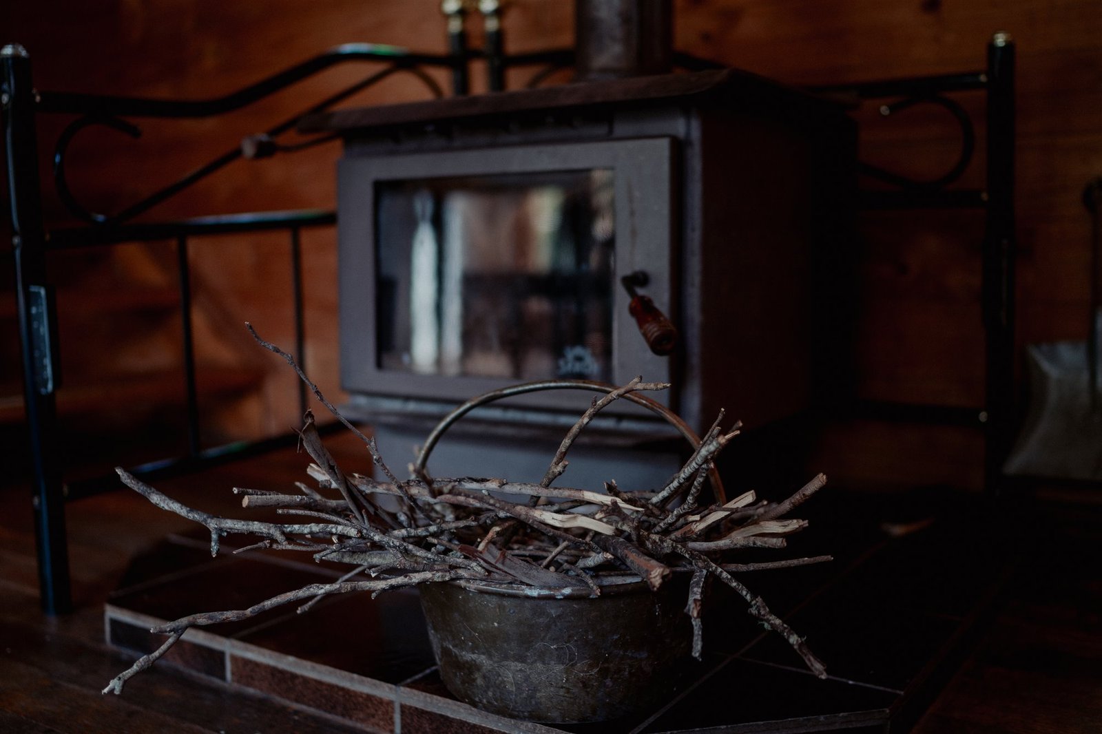 Wood heater with kindling ready beside the fire